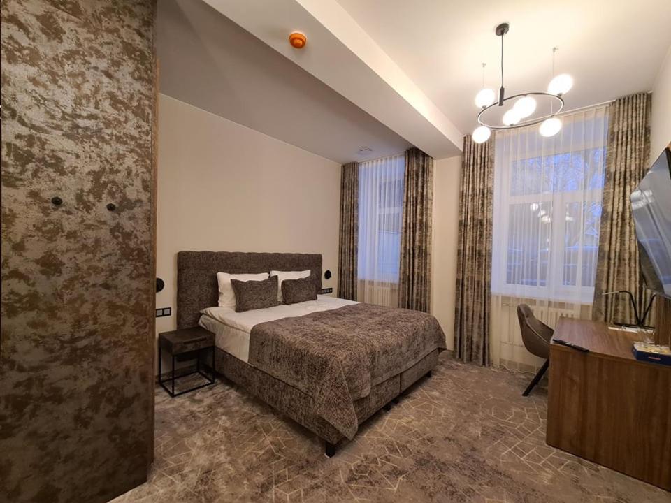 Кровать или кровати в номере Vvinn Hotel