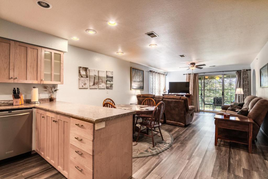 a kitchen and living room with a table and a couch at Quiet and Serene Condo in Branson in Branson