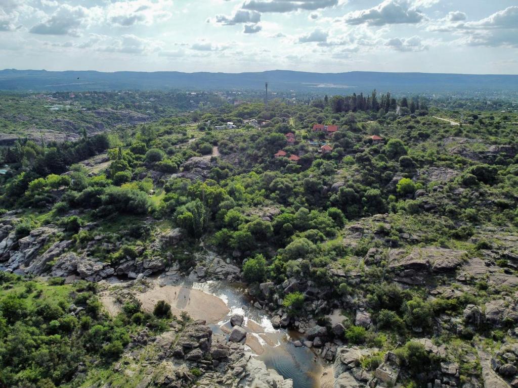 an aerial view of a river on a rocky mountain at Cabañas Del Rio in Mina Clavero