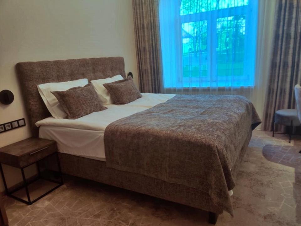 Postel nebo postele na pokoji v ubytování Vvinn Hotel