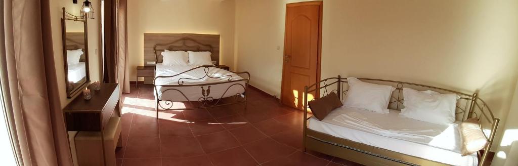 A bed or beds in a room at Villa Melody Complex
