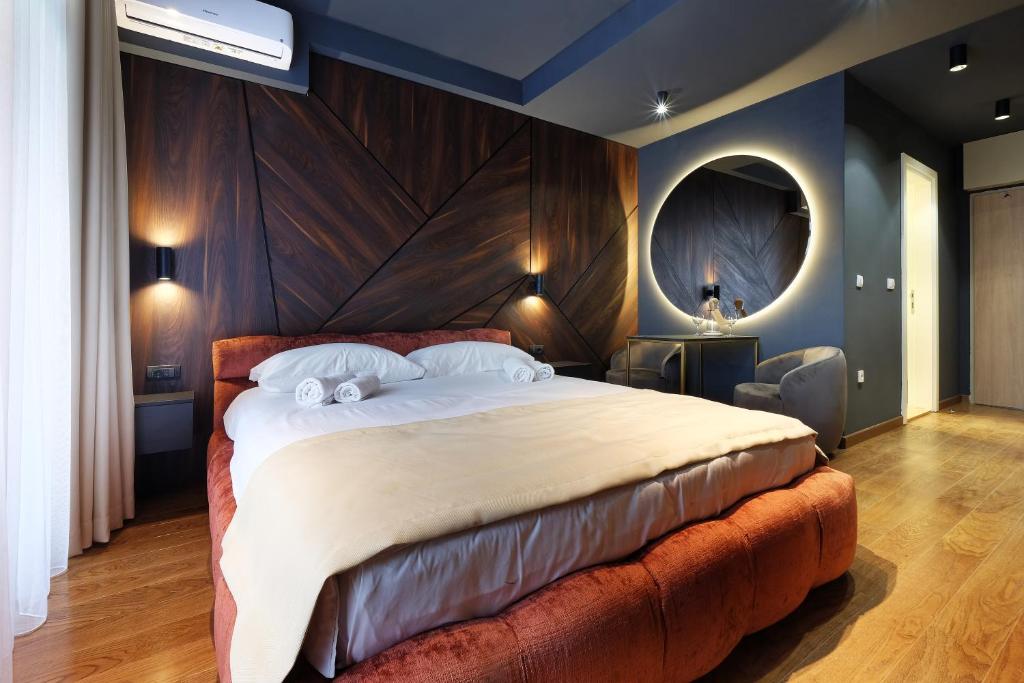 - une chambre avec un grand lit et une grande tête de lit en bois dans l'établissement Belgrade Waterfront Apartments - Arcadia, à Belgrade