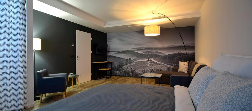 a bedroom with a bed and a painting on the wall at CITYMAP HOTEL APPARTMENTS Maribor-Free parking! in Maribor
