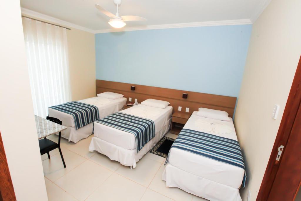 מיטה או מיטות בחדר ב-Avenida Palace Hotel