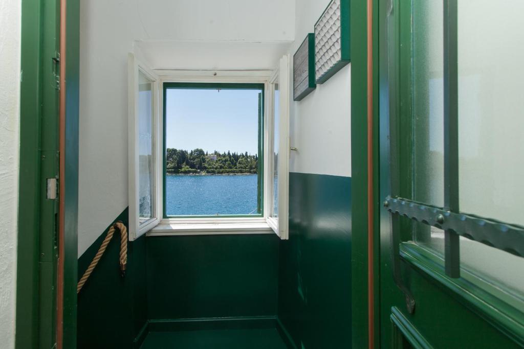 a bathroom with a window and a view of the water at Casa Sul Mar in Rovinj