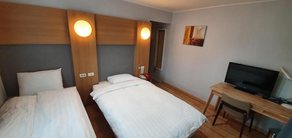 Postel nebo postele na pokoji v ubytování Appletree Hotel Pohang