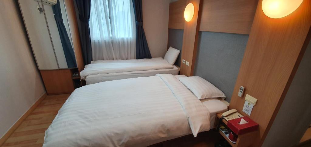 Postel nebo postele na pokoji v ubytování Appletree Hotel Pohang