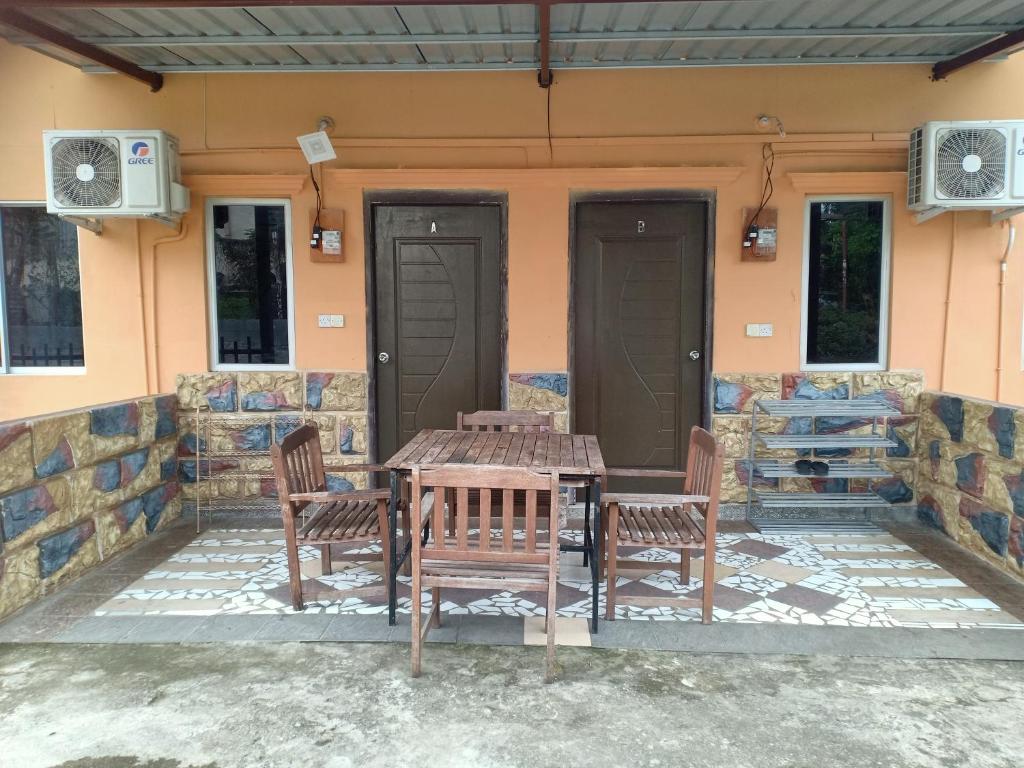 a table and chairs on the patio of a house at Homestay pekan ranau in Ranau