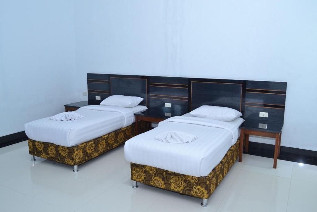 Postel nebo postele na pokoji v ubytování Malibou Hotel Medan