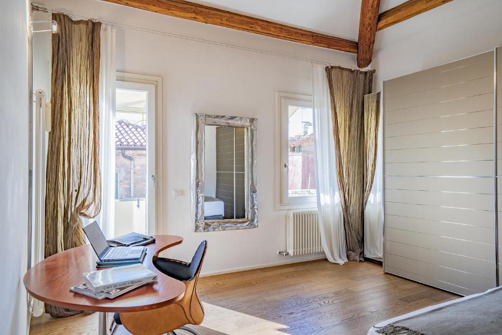 Pokój ze stołem i laptopem w obiekcie Colleoni Apartment with 2 Superb Terraces w Wenecji