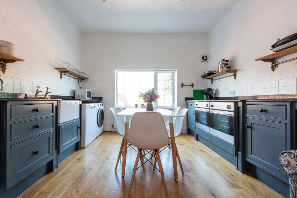 a kitchen with blue cabinets and a white sink at Riverside Rest in Ollerton