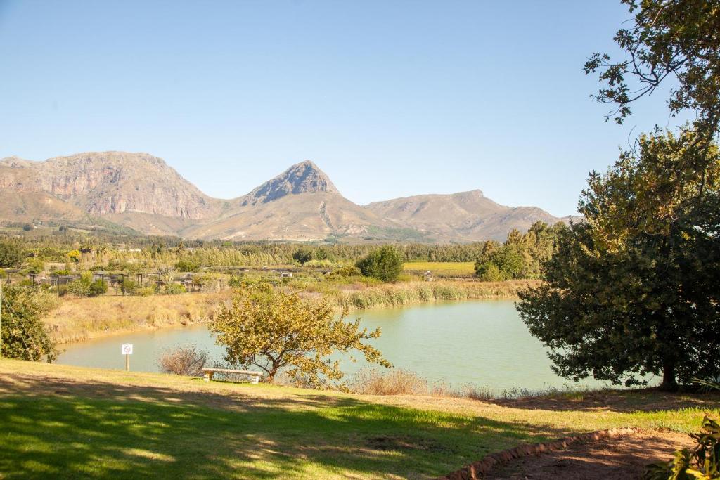 a view of a lake with mountains in the background at Le Héritage in Klein-Drakenstein