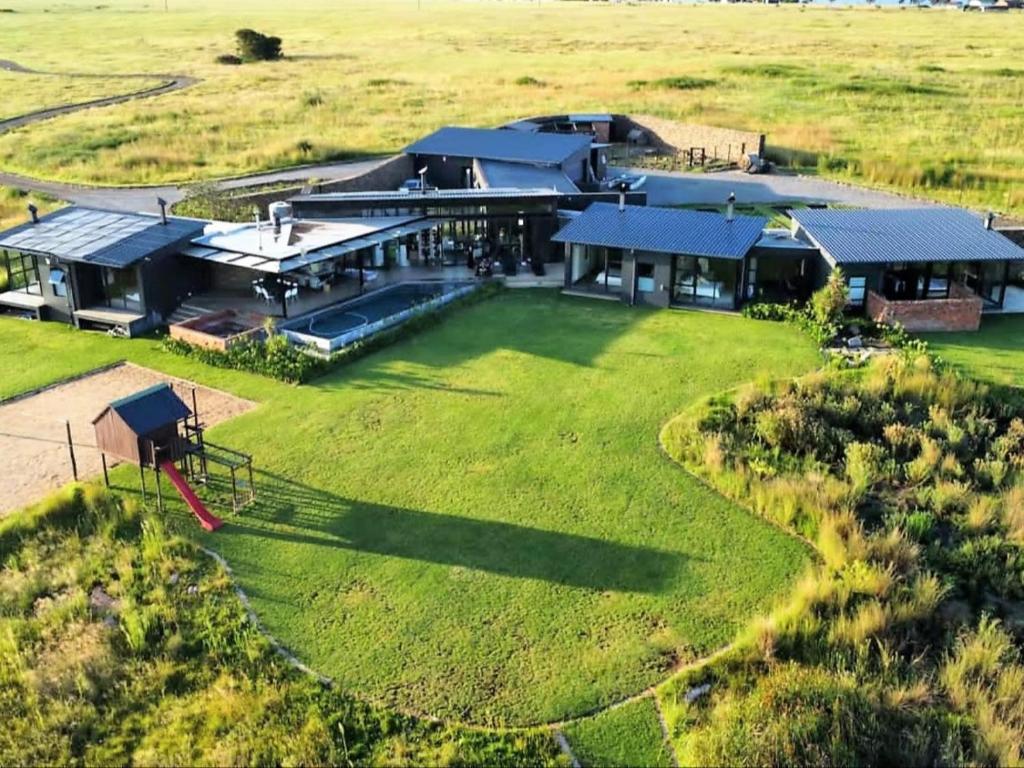an aerial view of a large house on a field at Letlapa Metsi in Denysville