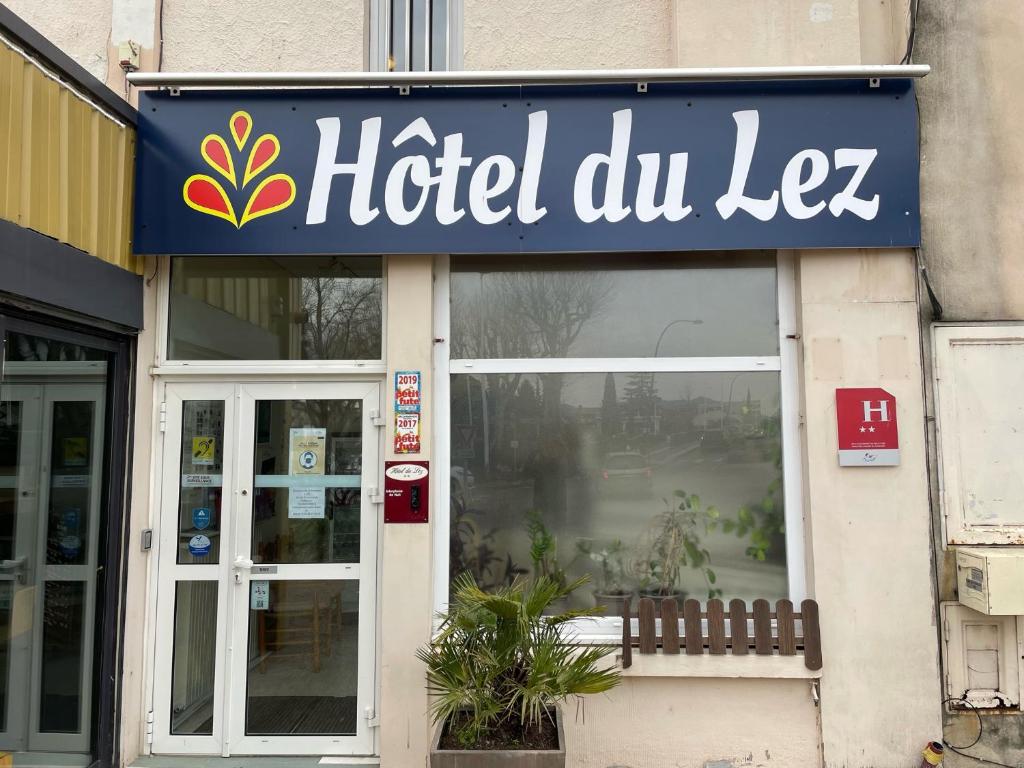 a hotel dulee sign on the side of a building at Hotel Du Lez in Bollène