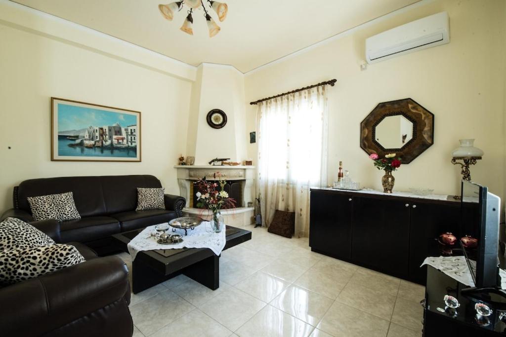 a living room with a couch and a table at Kreta House in Pómbia