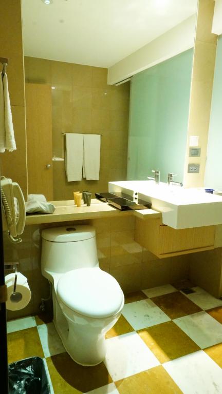 a bathroom with a white toilet and a sink at City Suites-Taipei Nanxi in Taipei