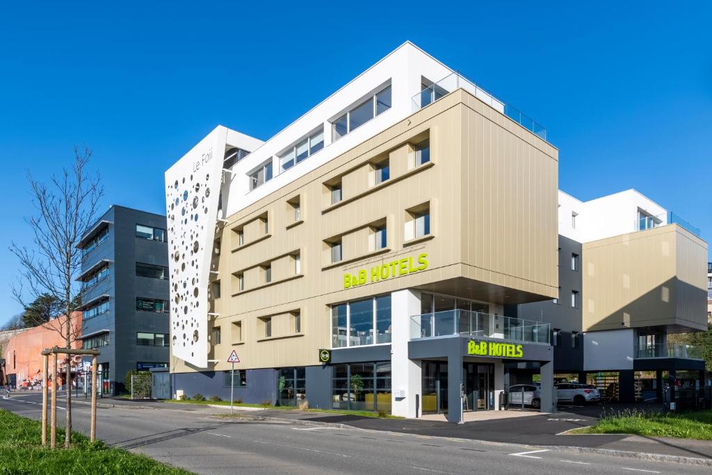 a large white building on the side of a street at B&B HOTEL Brest Centre Port de Commerce in Brest