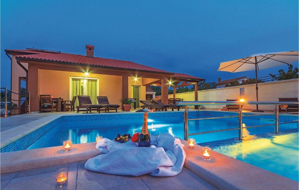a villa with a swimming pool at night at Beautiful Home In Marcana With Kitchen in Marčana