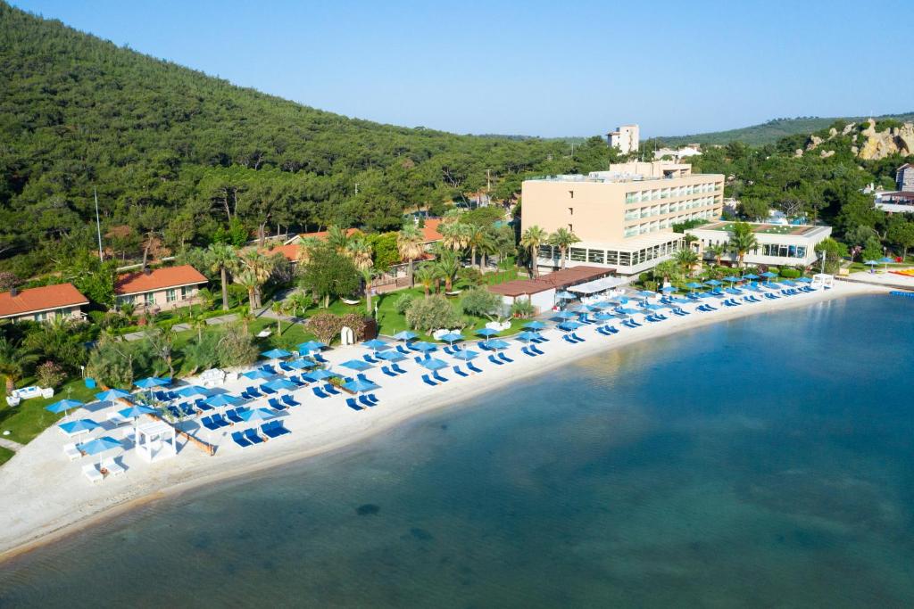 an aerial view of a beach with chairs and umbrellas at D - Resort Ayvalık in Ayvalık