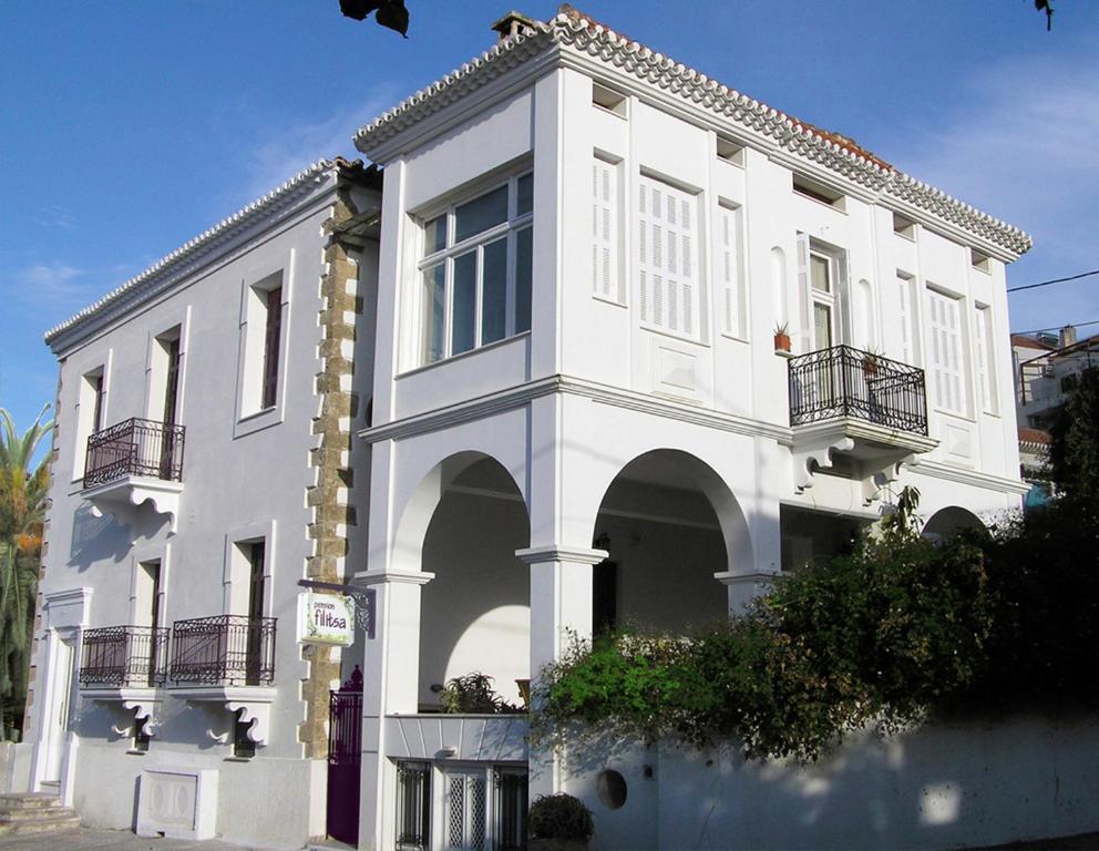 ピュロスにあるPension Filitsaの通りに面したアーチや窓のある白い建物