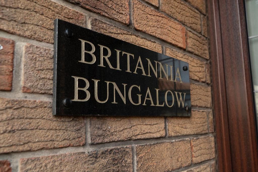 a sign on the side of a brick building at The Olde Ship Inn in Seahouses