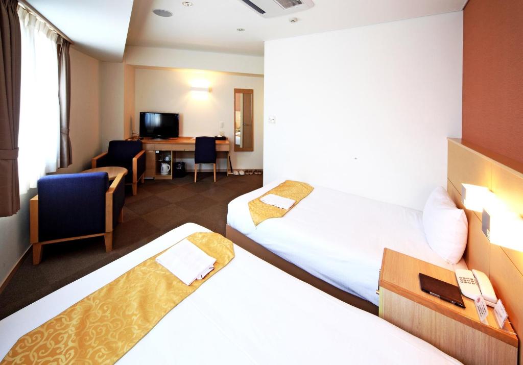 Postel nebo postele na pokoji v ubytování Hotel Sunplaza Osaka Sakai Annex