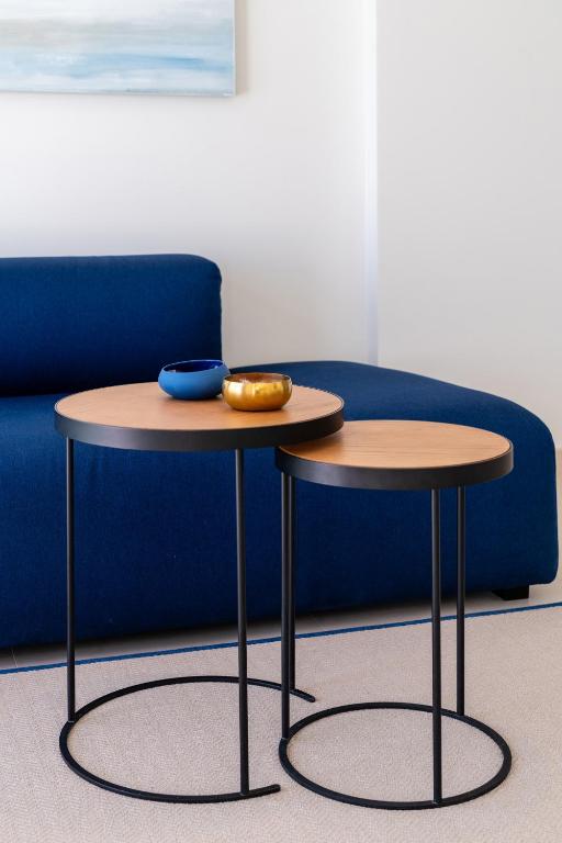 a pair of tables in front of a couch at Royal Marina Suites Boutique Hotel - Adults Only in Puerto Calero