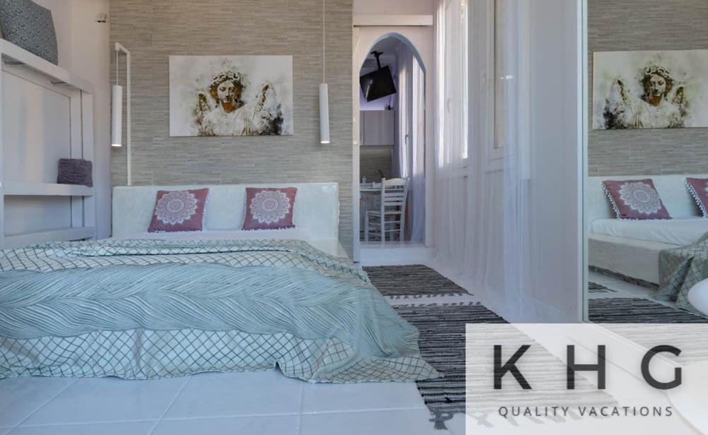 a bedroom with a king bed and a mirror at KEFALONIA'S HIDDEN GEMS! in Argostoli