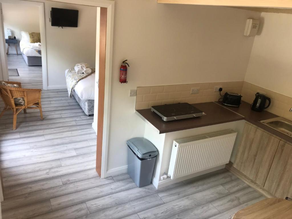 a kitchen with a counter and a trash can at Ardmore Log Cabins in Drumahoe