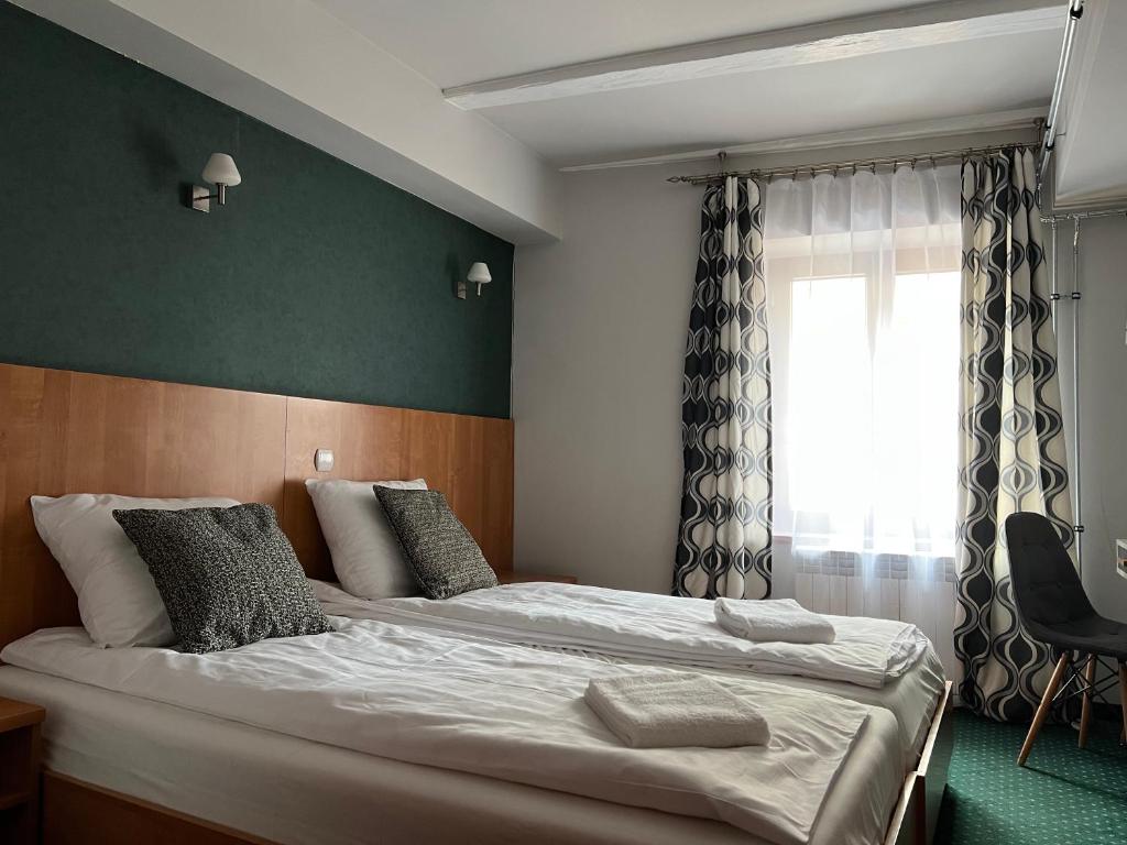 Postel nebo postele na pokoji v ubytování Garbarska 22 Aparthotel