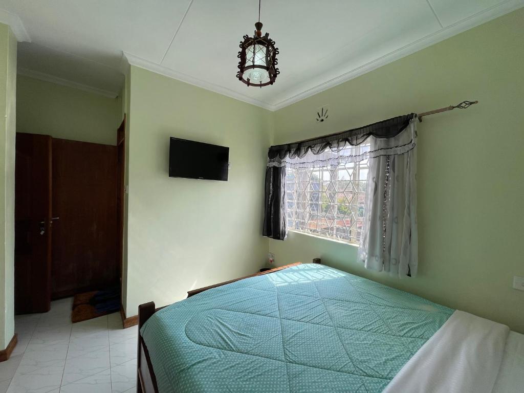 Ένα ή περισσότερα κρεβάτια σε δωμάτιο στο Home Stay Executive Guest House Nairobi