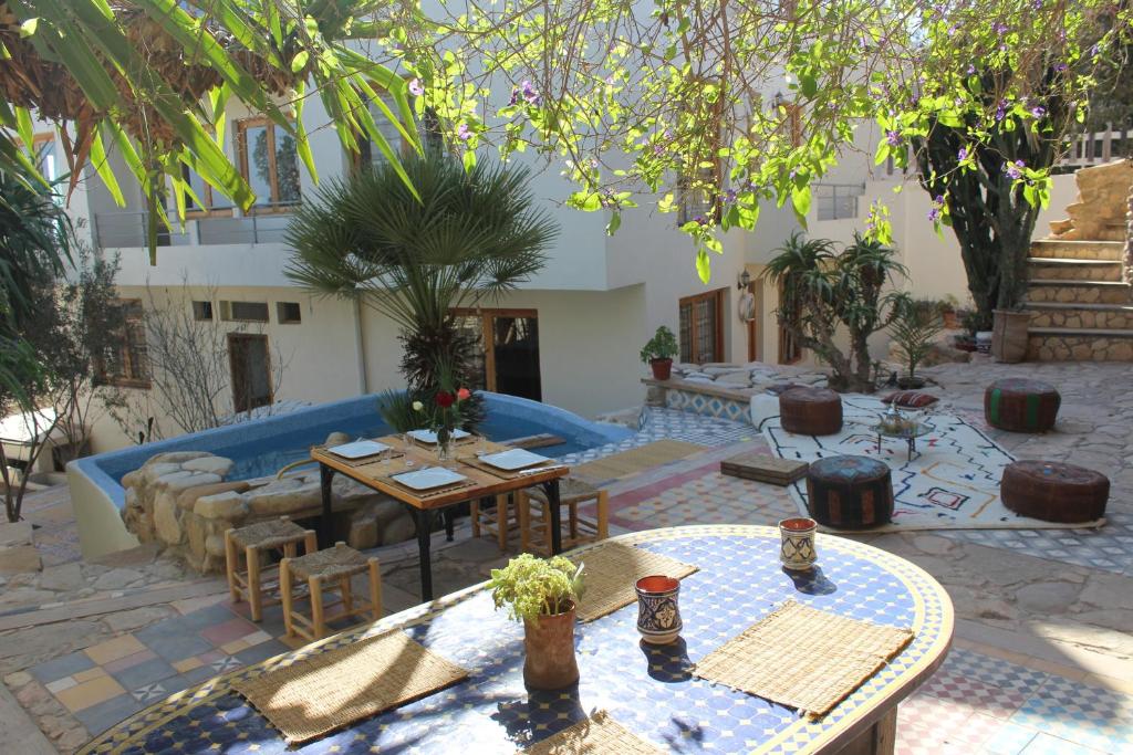 a patio with tables and chairs in a courtyard at Taghazout Hill Retreat in Taghazout