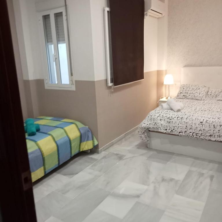Posteľ alebo postele v izbe v ubytovaní Apartamentos centro histórico
