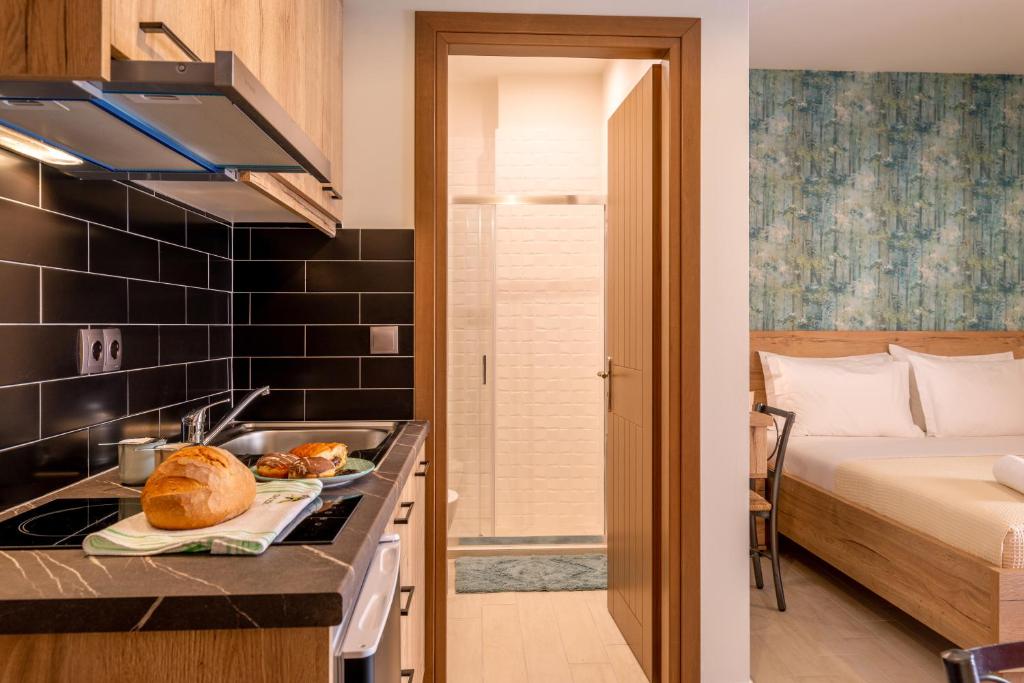 a kitchen with a sink and a bed in a room at Τrilogy Studios in Syvota
