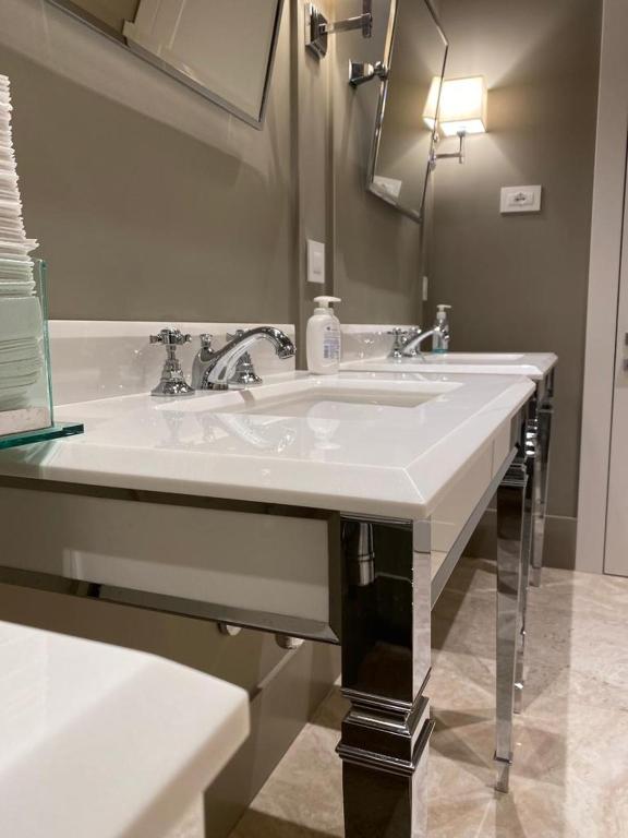 a bathroom with a white sink and a mirror at EUROPA Hotel in Vasto