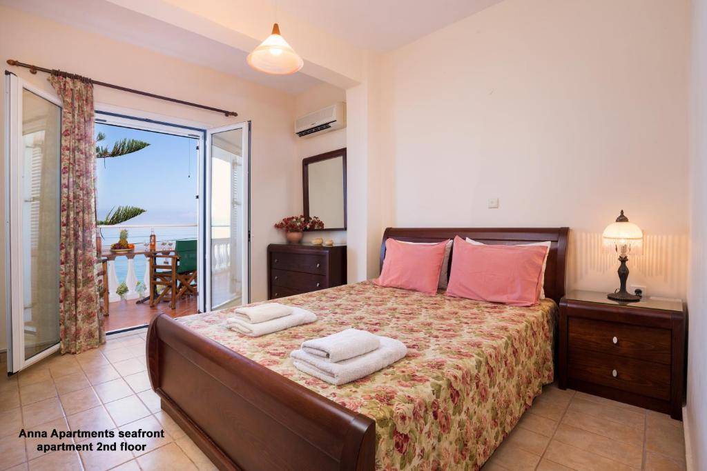 a bedroom with a bed with two towels on it at Anna Apartments Boukari in Boukari