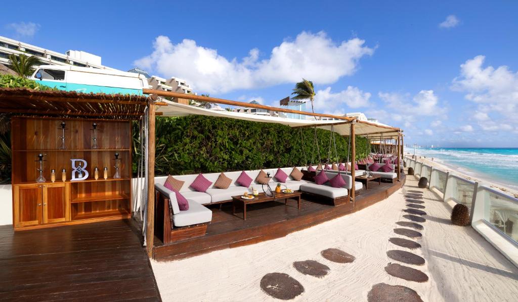a restaurant on the beach near the ocean at Paradisus Cancun All Inclusive in Cancún