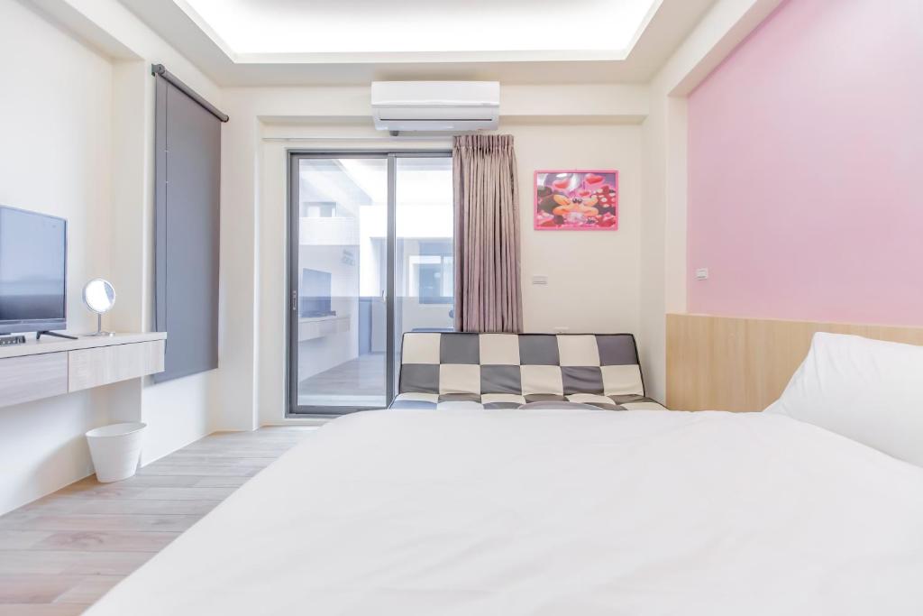 Postel nebo postele na pokoji v ubytování WOW Penghu Homestay
