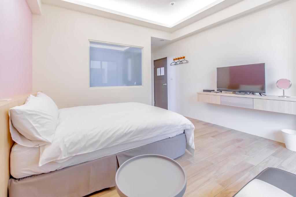 Postel nebo postele na pokoji v ubytování WOW Penghu Homestay