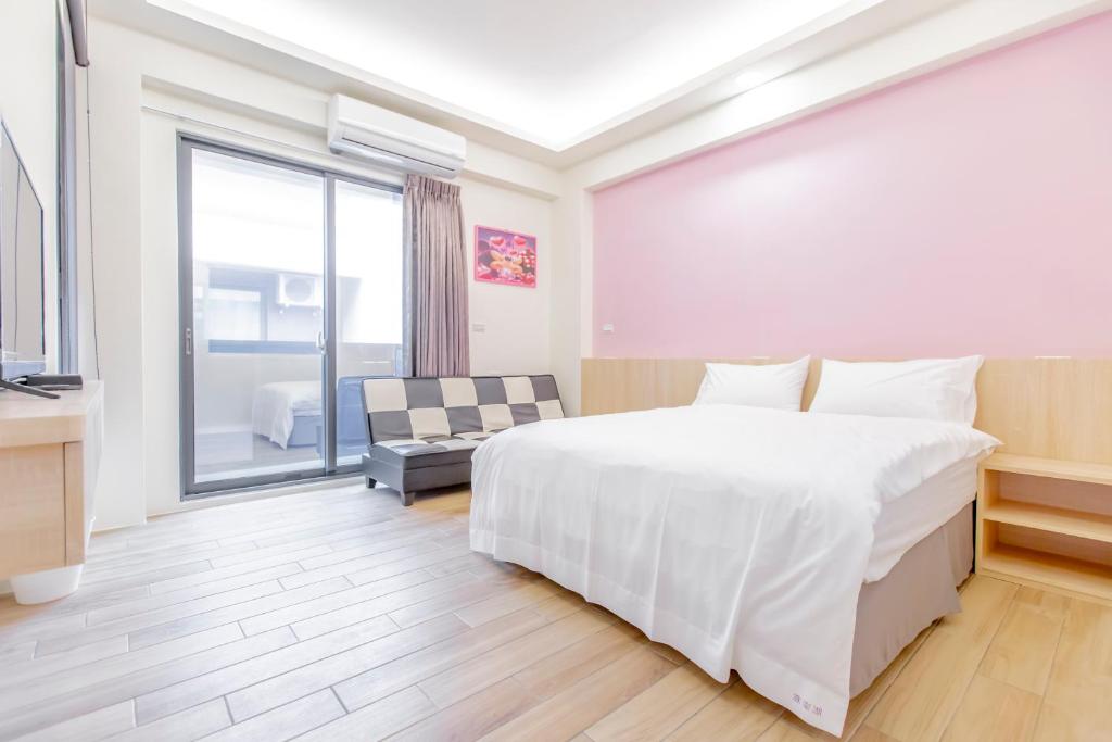 Postel nebo postele na pokoji v ubytování WOW Penghu Homestay