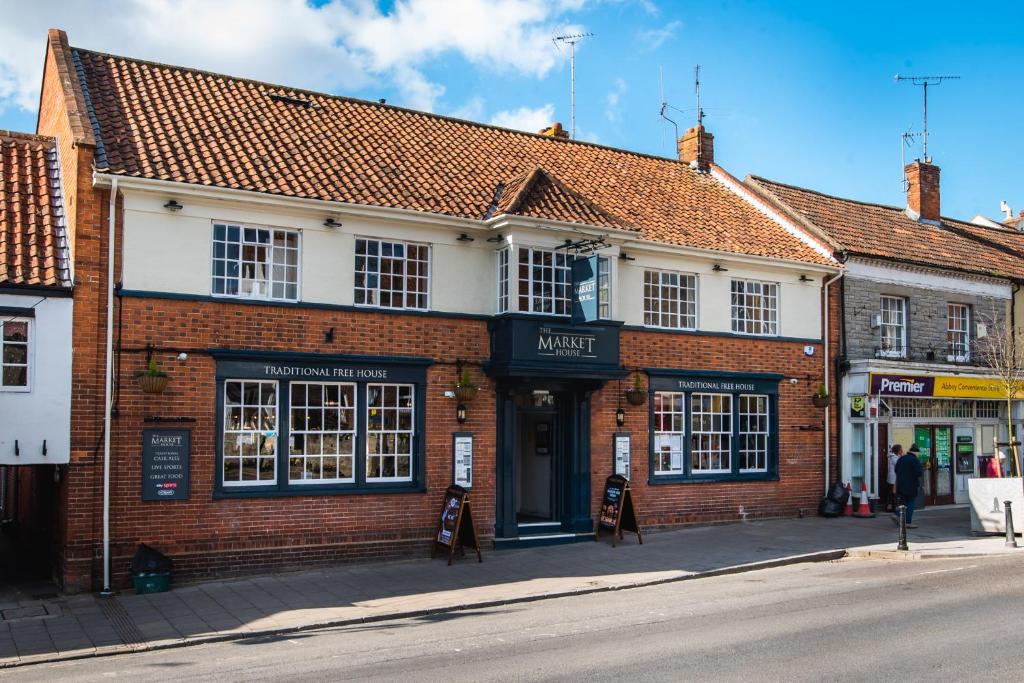 un edificio de ladrillo en la esquina de una calle en The Market House, en Glastonbury