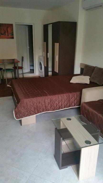 a hotel room with a bed and a coffee table at Апартаментен Комплекс Сплендид - Студио Афродита, № 113 in Varna City