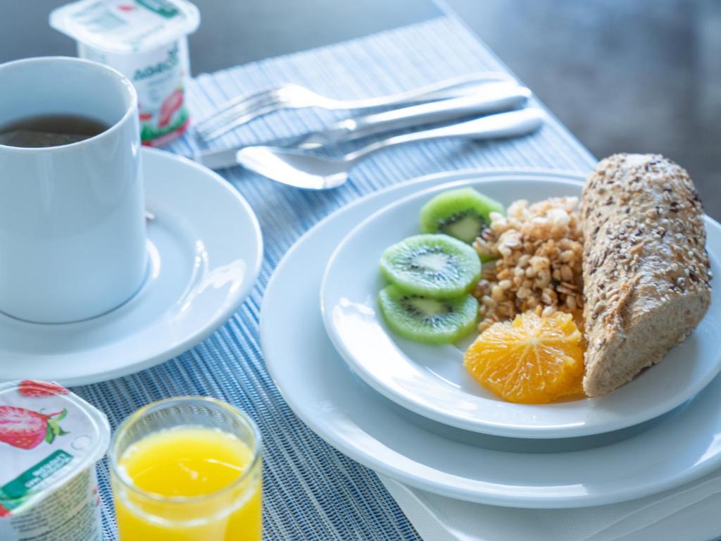 a plate of breakfast food with a cup of coffee at A House in Estoril - Adults Only in Estoril