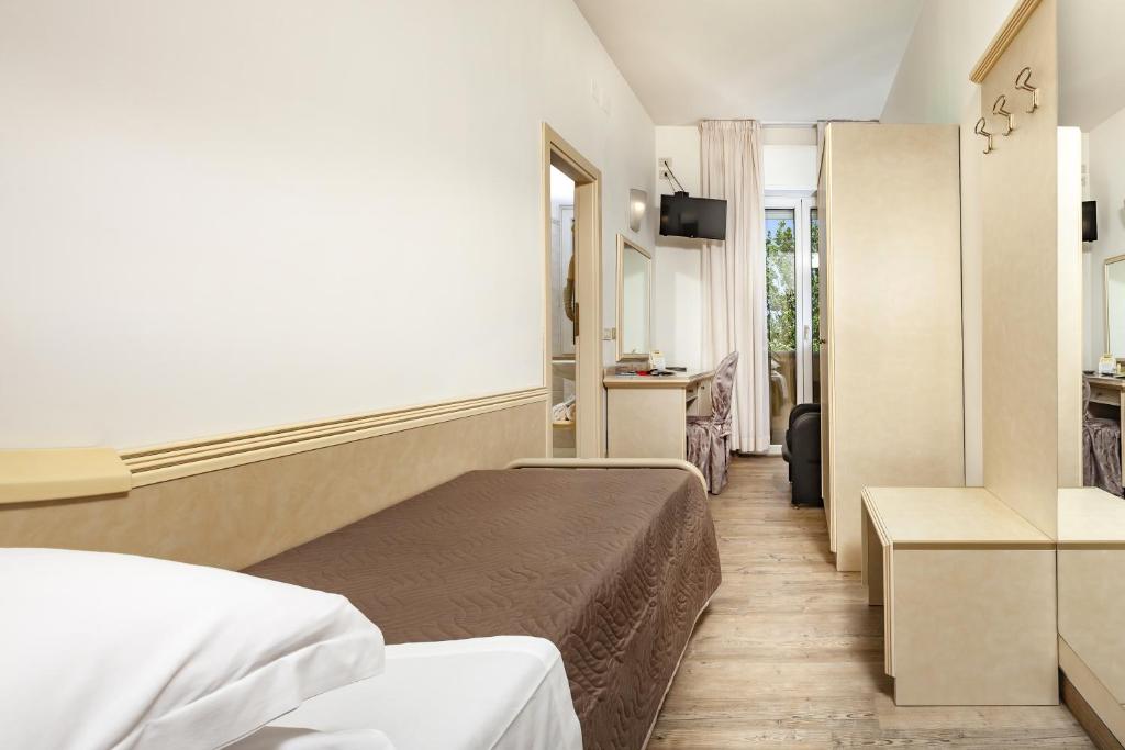 Postel nebo postele na pokoji v ubytování Ariminum Hotel