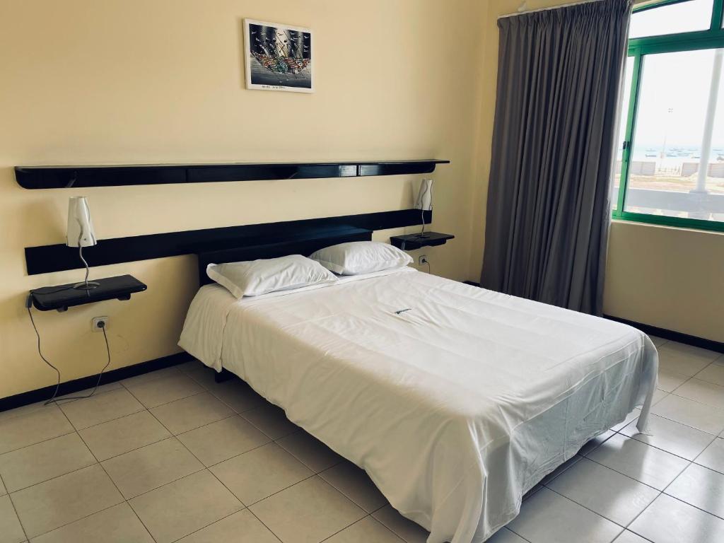 Postel nebo postele na pokoji v ubytování ApartHotel NhaTerra