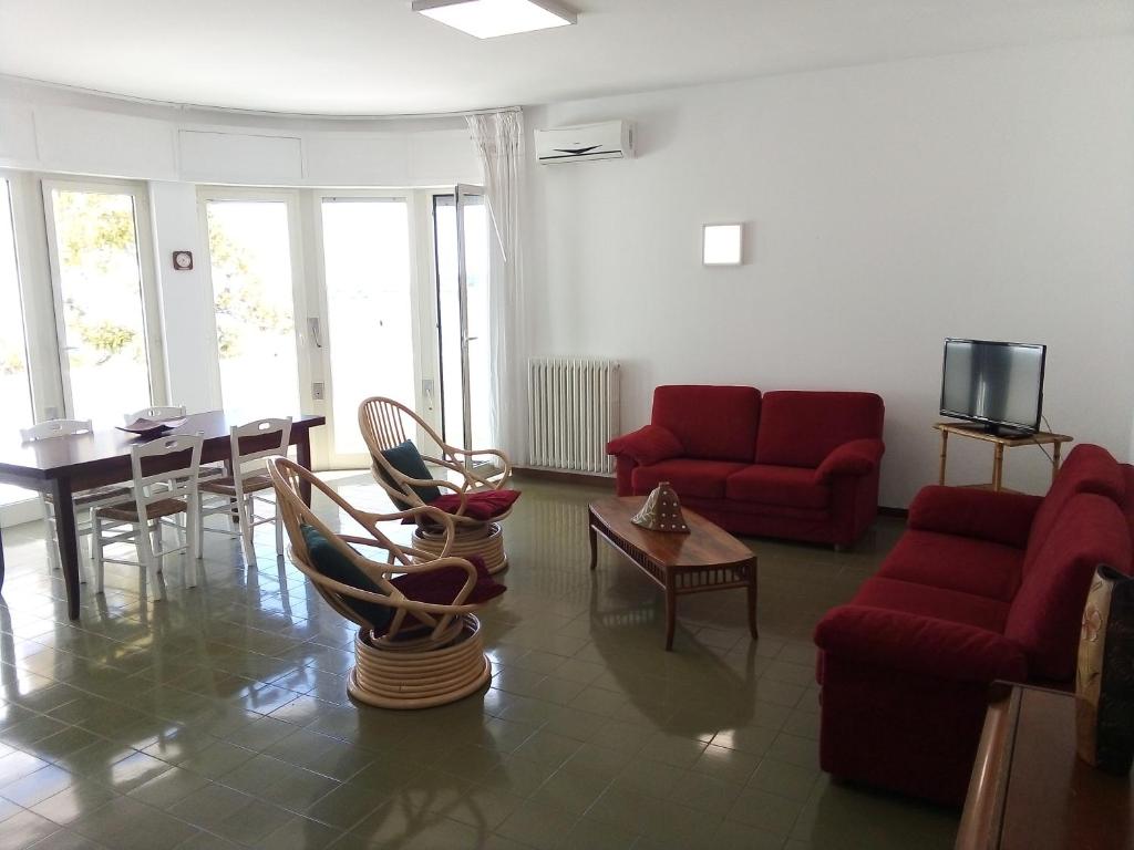 a living room with red couches and a table at Le Dimore di Otranto - Altomare in Otranto
