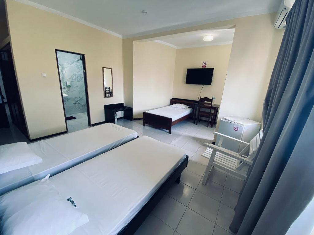Postel nebo postele na pokoji v ubytování ApartHotel NhaTerra