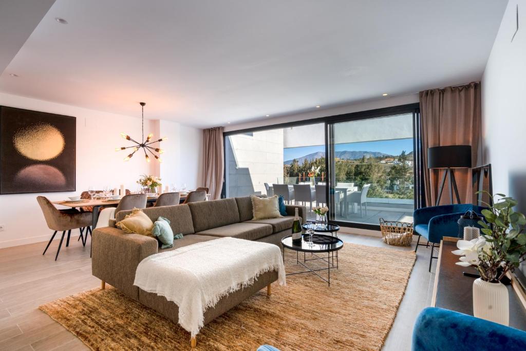 a living room with a couch and a table at Holiday Apartment Navigolf La Cala in La Cala de Mijas