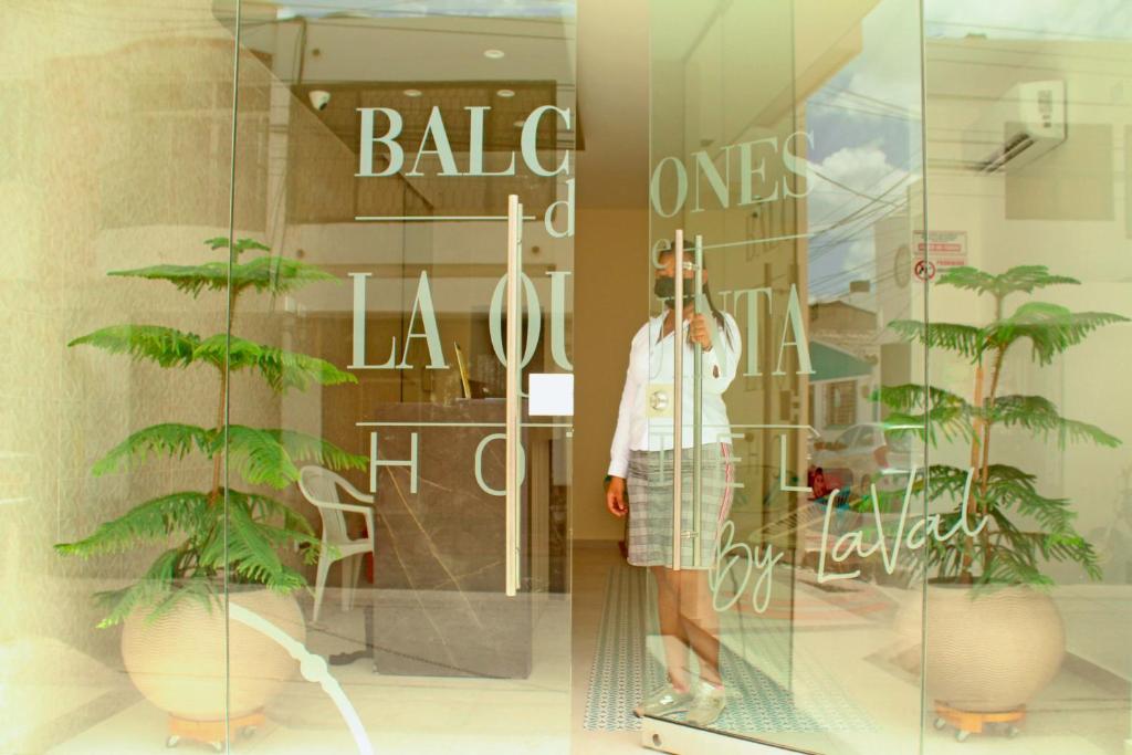 una mujer parada frente a la ventana de una tienda en Balcones de la Quinta, en Ríohacha