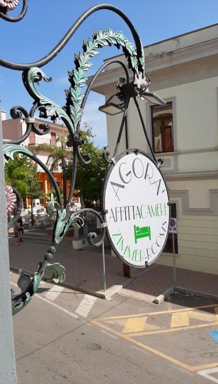 a sign for a restaurant on the side of a street at Affittacamere DOMO AGORA' in Tertenìa